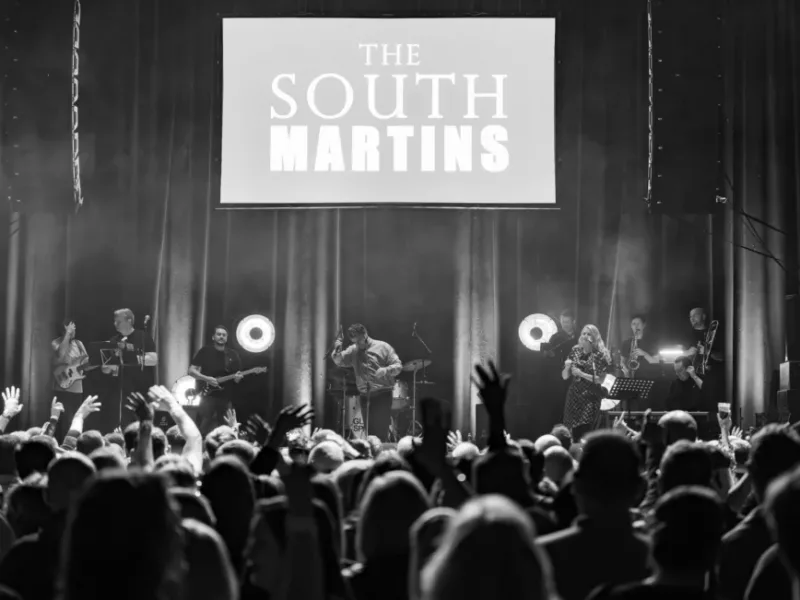 a black and white photo of a band on stage