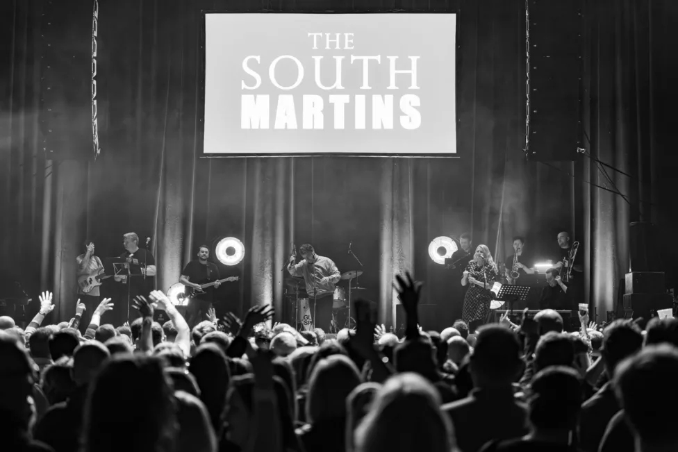 a black and white photo of a band on stage