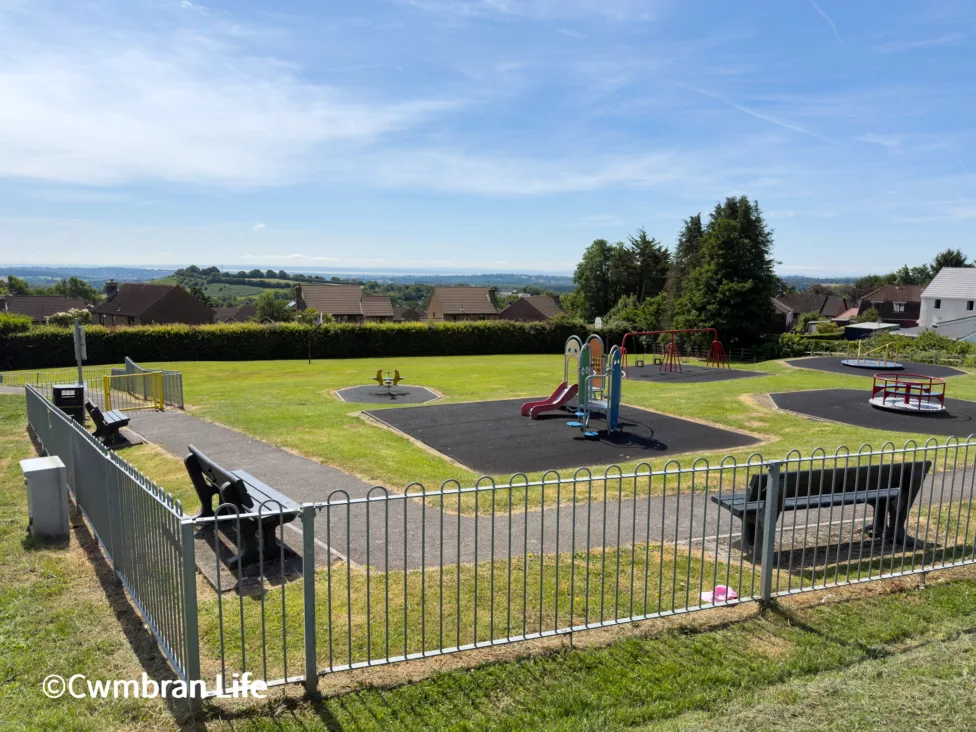 a park with a climbing frame and benches to sit on