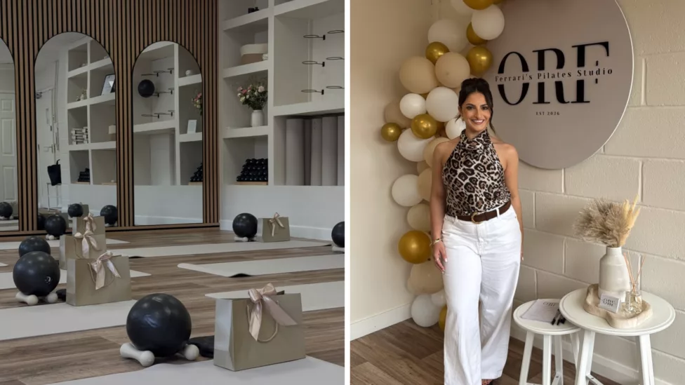 a photo of a pilates studio with mats on the floor and a women stood holding a drink