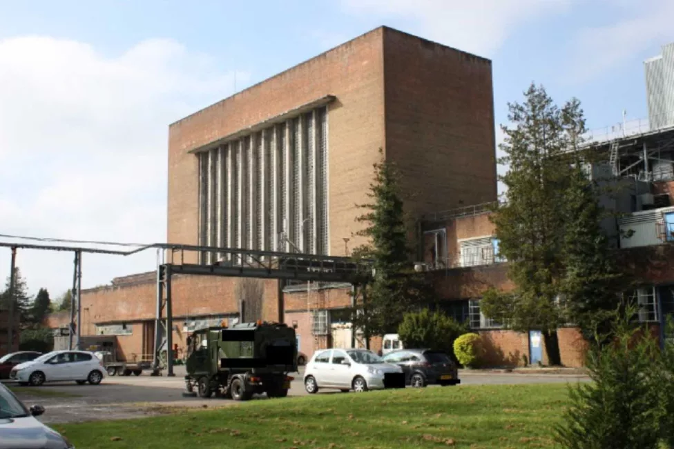 a large building with vehicles outside it
