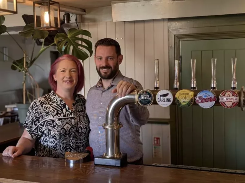 a man and woman behind a bar