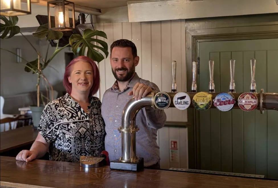 a man and woman behind a bar