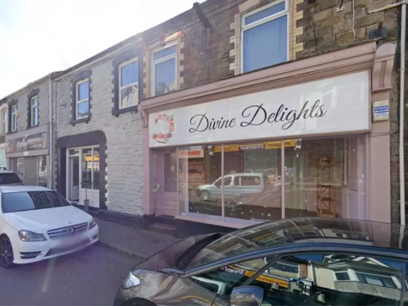 a street with a shop called divine delights on it