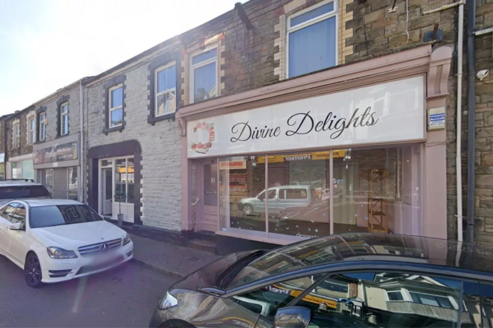a street with a shop called divine delights on it