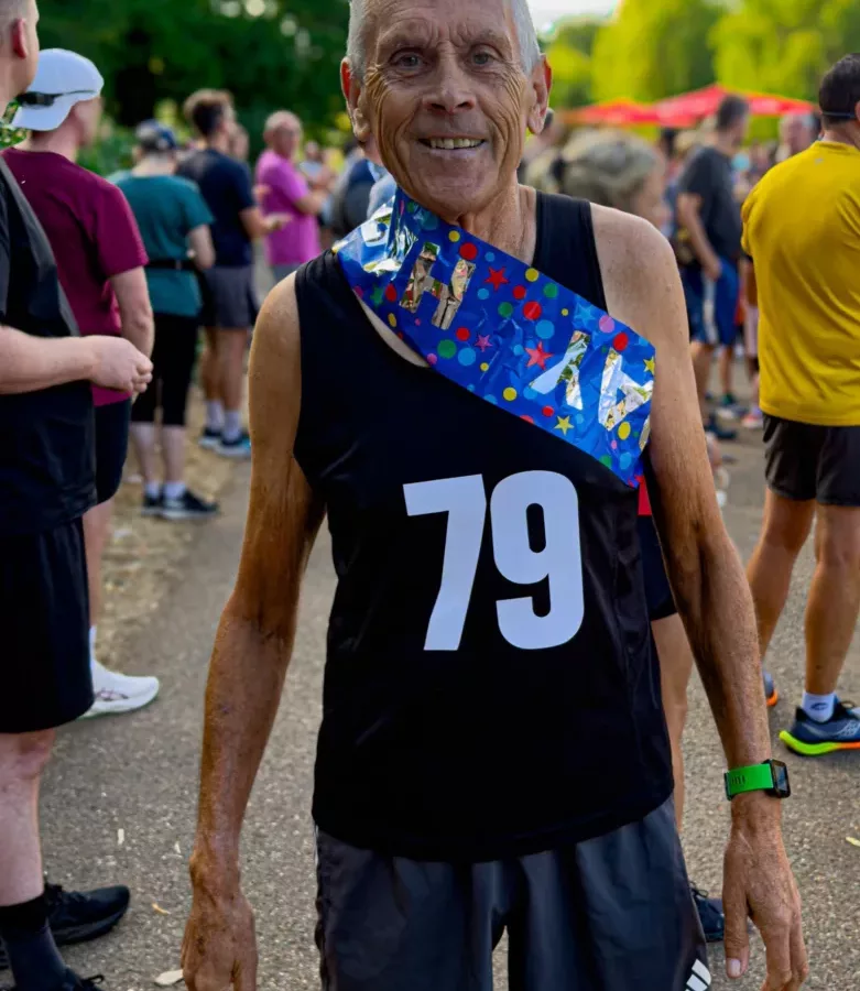 A man in running shorts and a vest with 79 on it