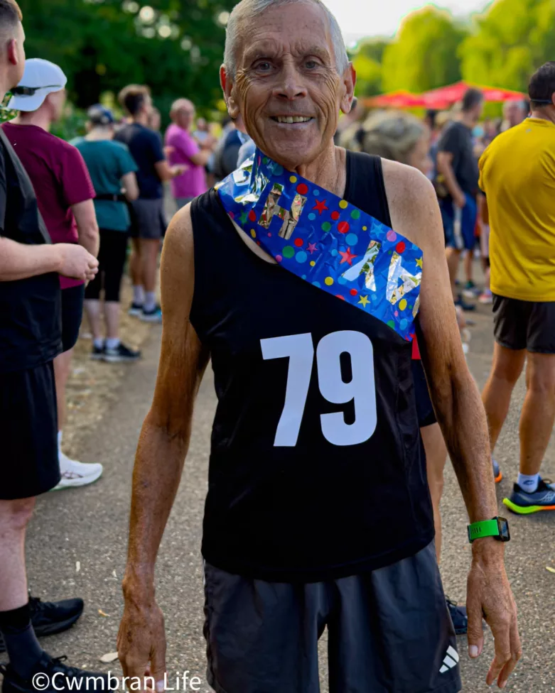 A man in running shorts and a vest with 79 on it