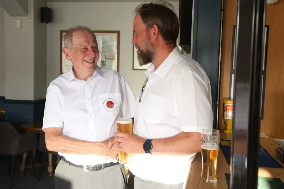 two men shake hands