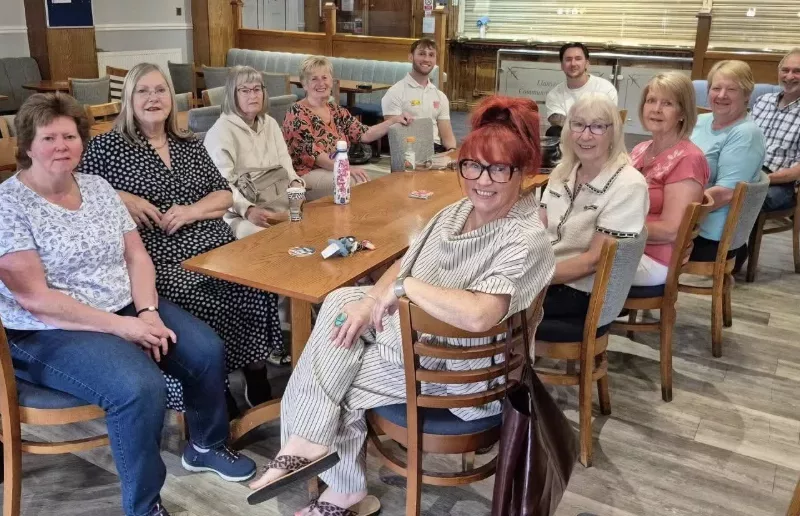 a group of men and women sat at