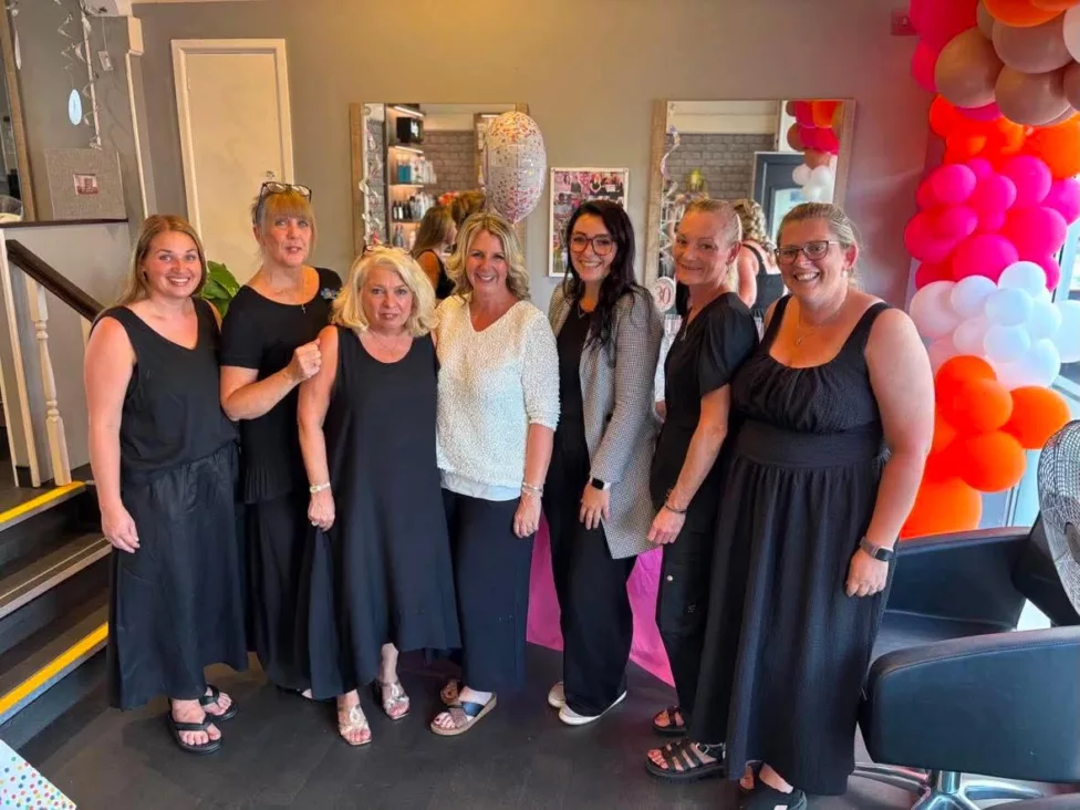 a group of women stood in a hairdressers