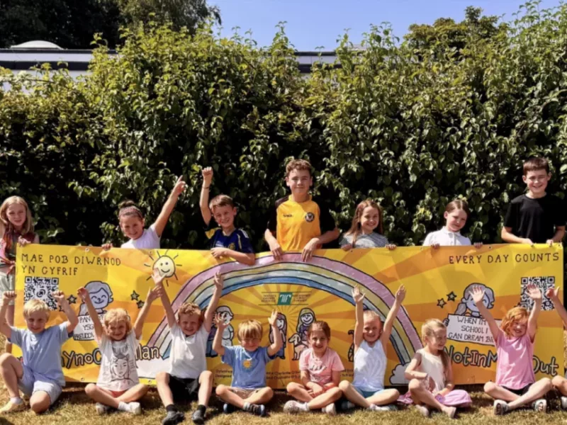a group of children cheer and clap in a garden