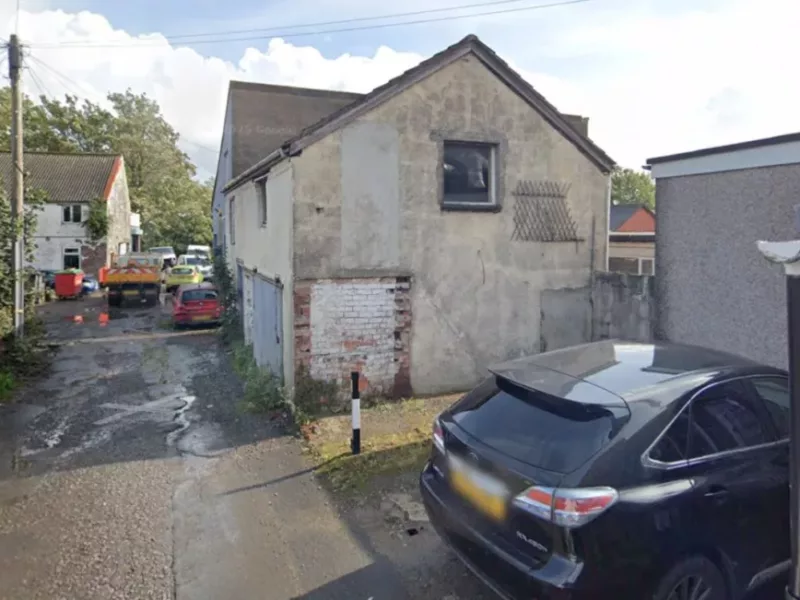 an old house with a car parked outside