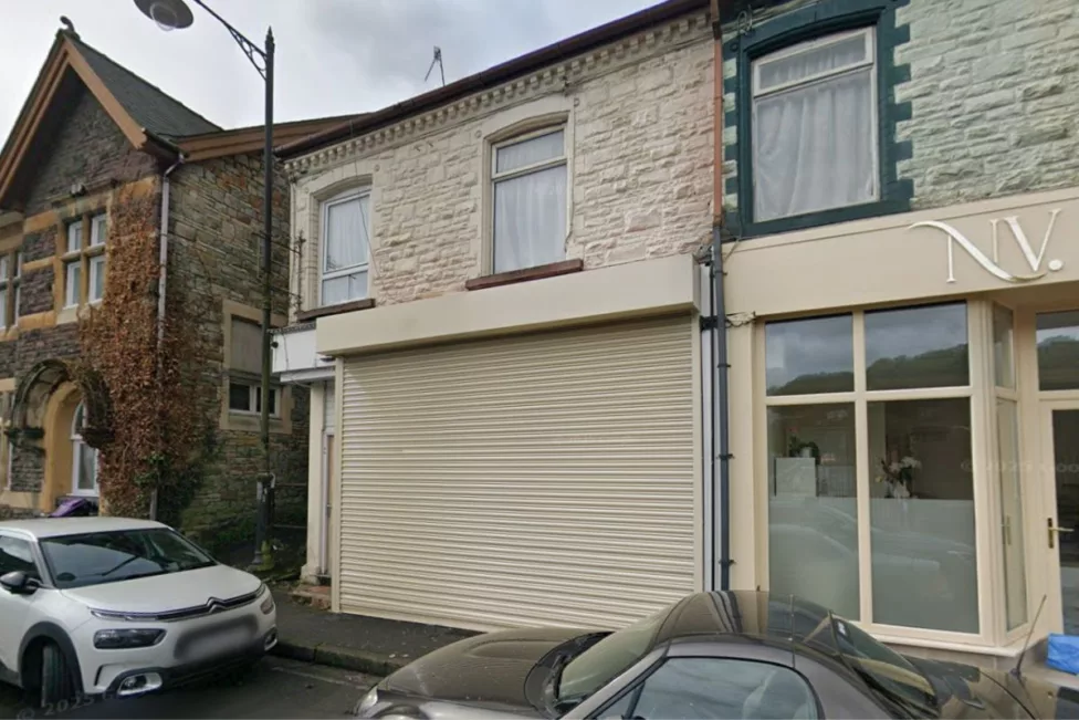 a shop with shutters over the windows