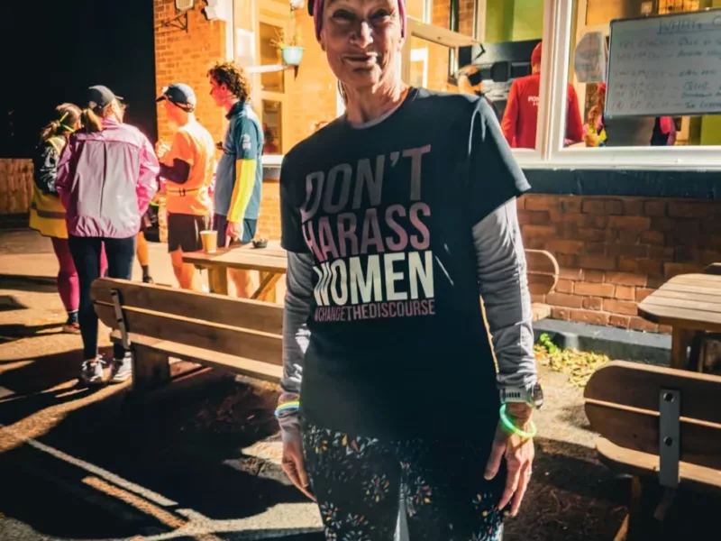 a woman wearing a t-shirt 'don't harass women'