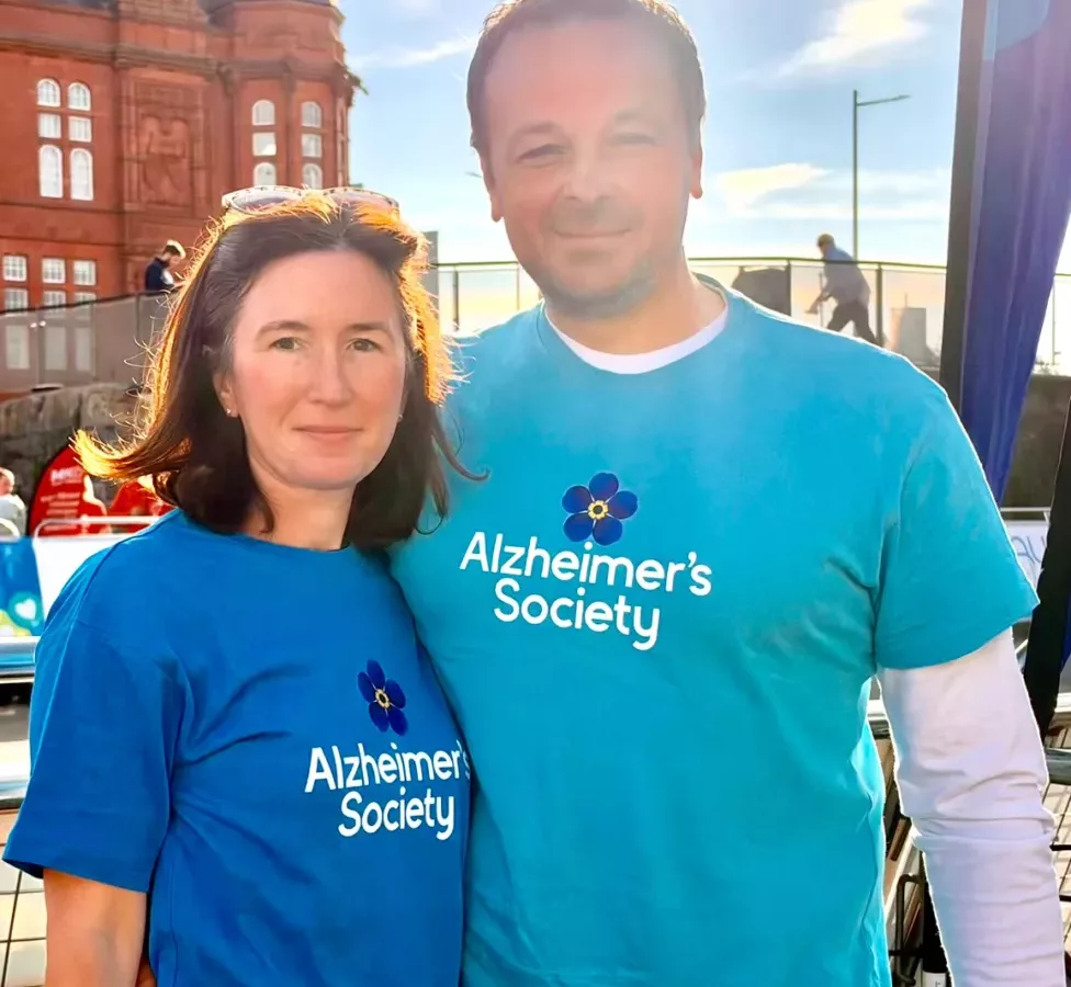 a man and woman wearing t-shirts with Alzheimer's Society on