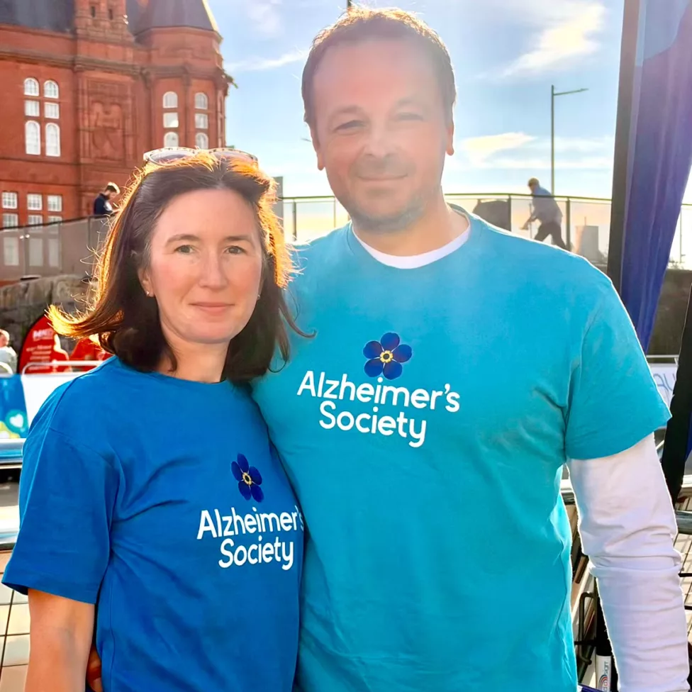 a man and woman wearing t-shirts with Alzheimer's Society on