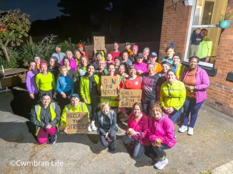 a group of men and women in running gear in a group